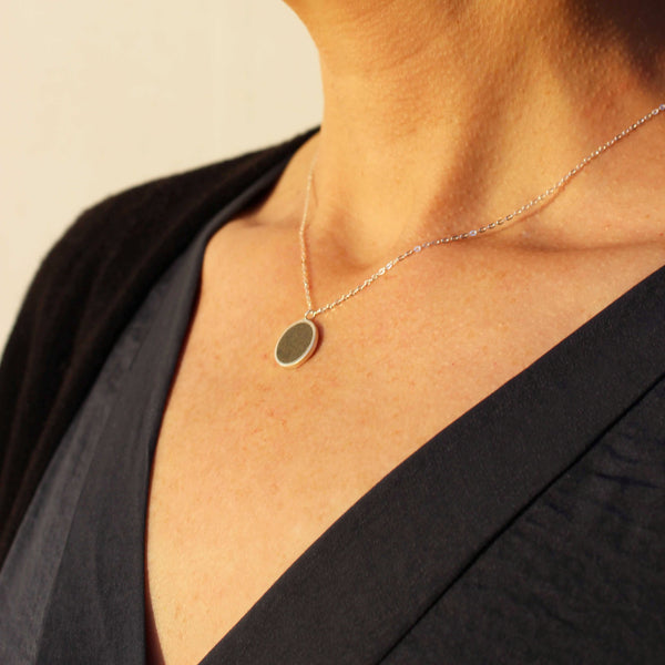 Round Silver and Concrete Necklace, by BAARA Jewelry. Close up on necklace. Layering necklace, silver necklace, delicate necklace, concrete jewelry
