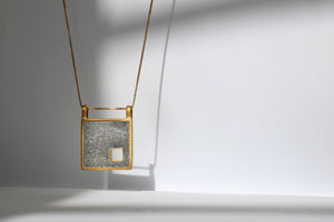 Gold and concrete necklace by BAARA. Gift for architect spouse